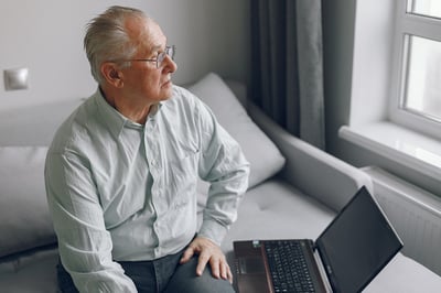 elegant-old-man-sitting-at-home-and-using-laptop