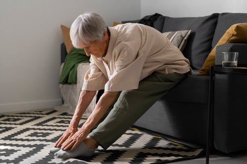 portrait-senior-woman-stretching-home