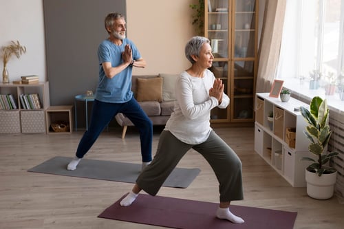 senior-couple-practicing-yoga-home
